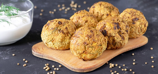 Falafel balls with coriander and parsley. Fresh vegetarian food. Vegetarian baked falafel with sauce.Healthy food.