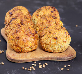 Falafel balls with coriander and parsley on a black background. Fresh vegetarian food. Vegetarian baked falafel with sauce.Healthy food.