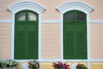 Double wooden shutters Old vintage style exterior decoration, green windows