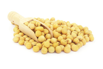 Heap of soy beans and wooden scoop isolated on white