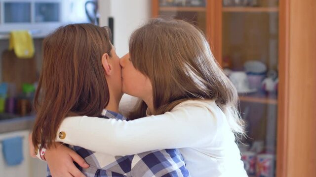 A Mother And Her Daughter Are Kissing And Hugging Each Other With Love