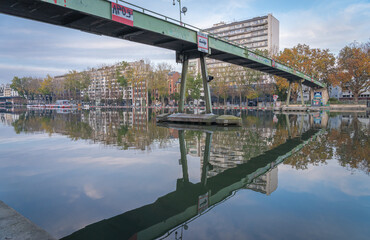 Paris, France - 11 07 2020: Reflections on Bassin de la Villette of great black cormorants on resting yellow buoys