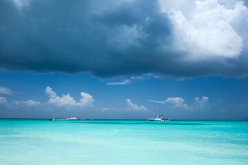 Boats in Caribbean waters, viewed from a tropical beach
