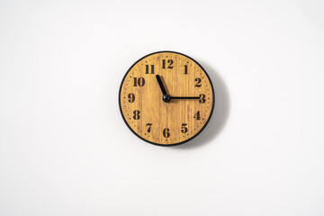 wood office wall clock with white dial on white background. wall clock on white background, top...