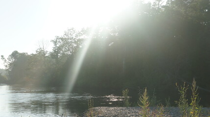 Blinding morning sunbeam, dawn on the river