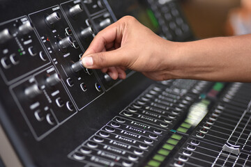  Sound engineer hand adjusting sound test adjust level on audio mixing
