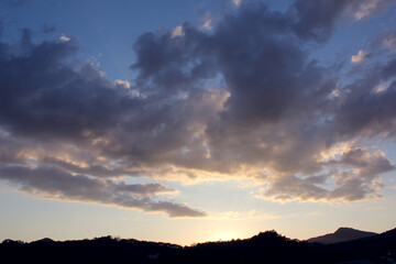 cloud and vanilla sky background with dark mountain silhouette