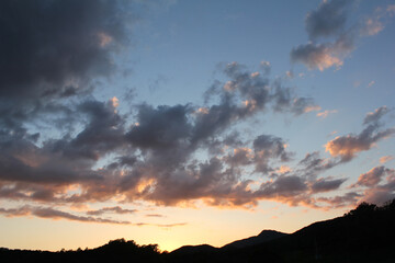 cloud and vanilla sky background with dark mountain silhouette