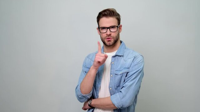Young caucasian handsome man keeping a secret or asking for silence with serious face