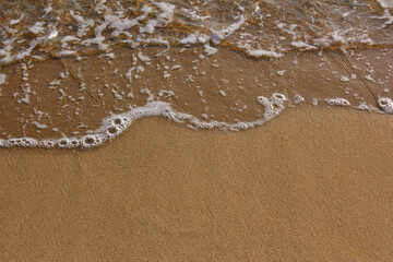 brown Sand beach and Wave foam.