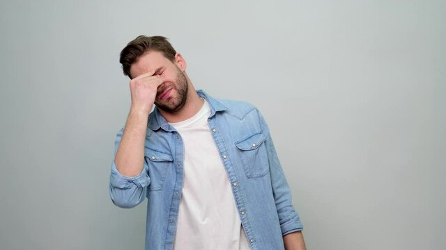 Portrait of tired stressed man holding hands on head guy having headache