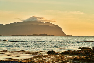 mystical mountain on the coast in the haze at sunrise