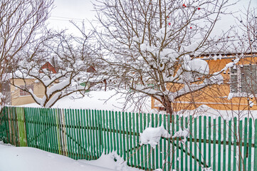 Real Russian winter, when frost and a lot of snow, in the country village, with small houses, roads through high snowdrifts
