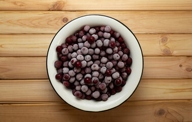 frozen cherries in an enamel bowl, healthy food concept, hoarfrost on berries