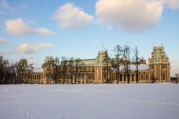 Fototapeta na wymiar Large beautiful Palace in the Tsaritsyno Park-reserve on a snowy winter day against a blue sky and a space for copying in Moscow Russia