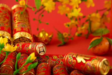Pile of firecrackers for Chinese New Year celebration, blooming apricot branches and tangerines