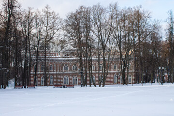 view of the Opera House Concert Hall in Tsaritsyno Park among bare trees on a winter day and a copy space against a background of white snow in Moscow Russia