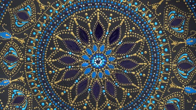 Decorative ceramic plate with black, blue and golden colors, painted plate on background, closeup, top view, rotate. Decorative porcelain plate painted with acrylic paints, handwork, dot painting