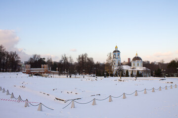 Orthodox blue Church of the icon of the mother of God in Tsaritsyno Park on a clear winter day against the background of snow and bare trees with space to copy in Moscow Russia