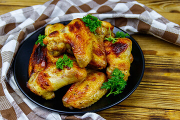 Baked chicken wings on a wooden table