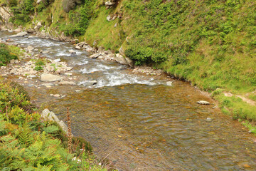 Heddon river flowing through the valley and over rocky ground