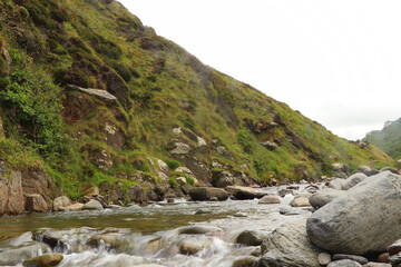 Heddon river flowing through the valley and over rocky ground