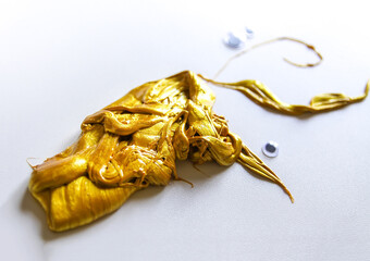 Gold slime and handmade details on white background