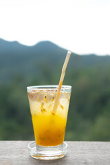 Transparent glass with tasty healthy freshly made passion fruit juice.