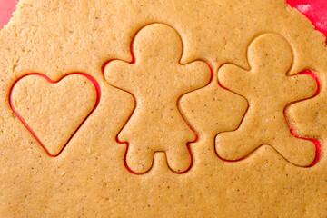 Cutting gingerbread shapes. Family or love couple concept from dough for St. Valentines Day. 