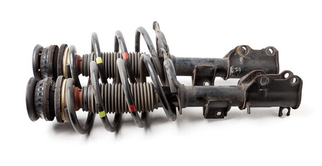 Two shock absorber struts with black springs after being used on a car during replacement and repair on a white isolated background. Used spare parts. Auto parts catalog. - obrazy, fototapety, plakaty