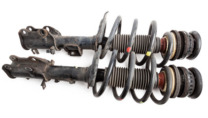 Two shock absorber struts with black springs after being used on a car during replacement and...