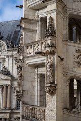 Fototapeta na wymiar Statue and detail of the façade of the Blois castle on the banks of the Loire in France