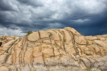 formation in the desert with storm clouds - 401803495