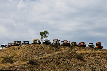 A line of old cars, trucks and vehicles on a hill in Arizona - 401804290