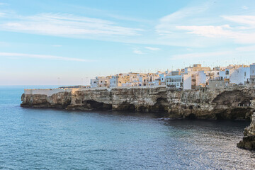 Fototapeta na wymiar Beautiful view of the buildings on the rocks and view of the sea from Polignano a mare, province of Bari in Puglia, famous tourist destination in southern Italy.
