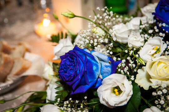 Fiori e rose blu alla luce delle candele in un giorno speciale