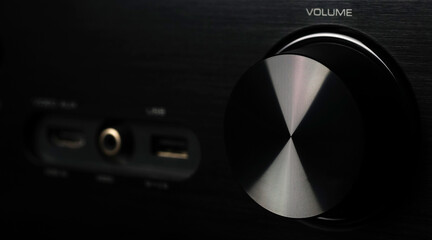 Front side of the AV receiver with volume knob close-up.