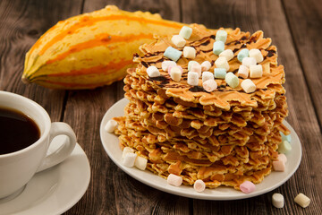 A closeup shot of a plate of crispy waffles and a cup of coffee