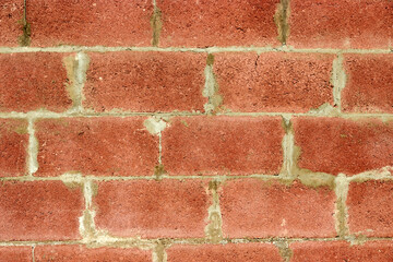 texture of wall is made of red concrete blocks