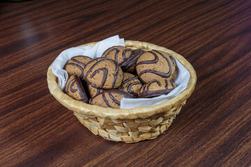 Dark chocolate butter cookies in a straw basket.