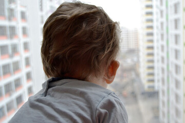 Beautiful baby boy with child face posing photographer near window