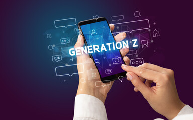 Female hand typing on smartphone with GENERATION Z inscription, social media concept
