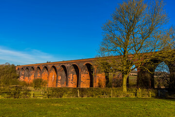 Fototapeta na wymiar A close up view of the Victorian railway viaduct for the London and North Western Railway at John O'Gaunt valley, Leicestershire, UK in winter