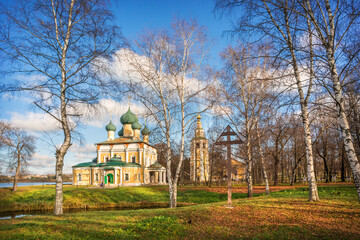 Transfiguration Cathedral with a bell tower among the trees of the park in the Kremlin of Uglich