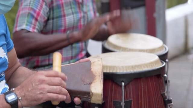 Take a closer look at musicians playing salsa in the streets of Santo Domingo, to brighten up the sorrows, left by the devastating covid 19