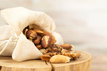 the mixture of nuts is poured out of the bag onto a wooden stand. Close-up, macro