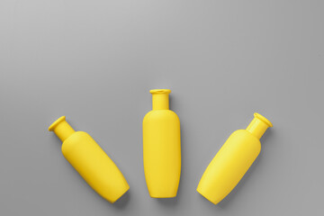 Yellow cosmetic container on gray background top view