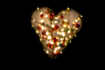 heart shape with defocused lights and black background. Valentine's Day