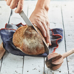Chef cutting Freshly Baked Sourdough Bread