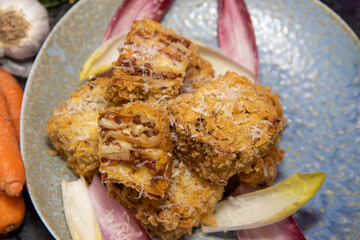 A delicious plate of deep fried Lasagna squares on a plate